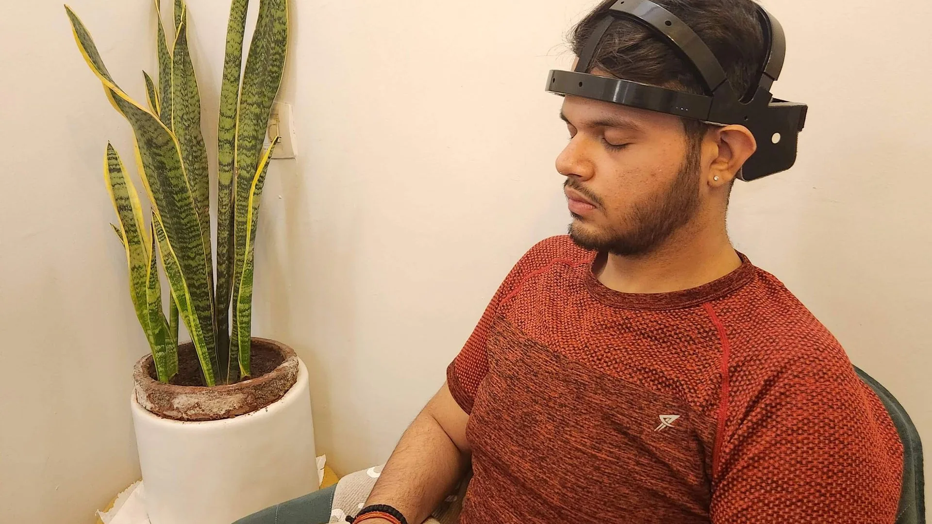A person wearing a wireless EEG headband.