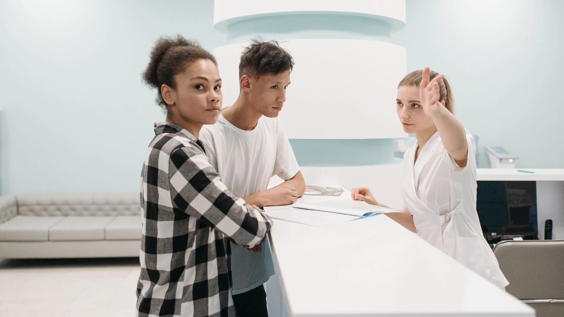 People at a clinic reception desk.