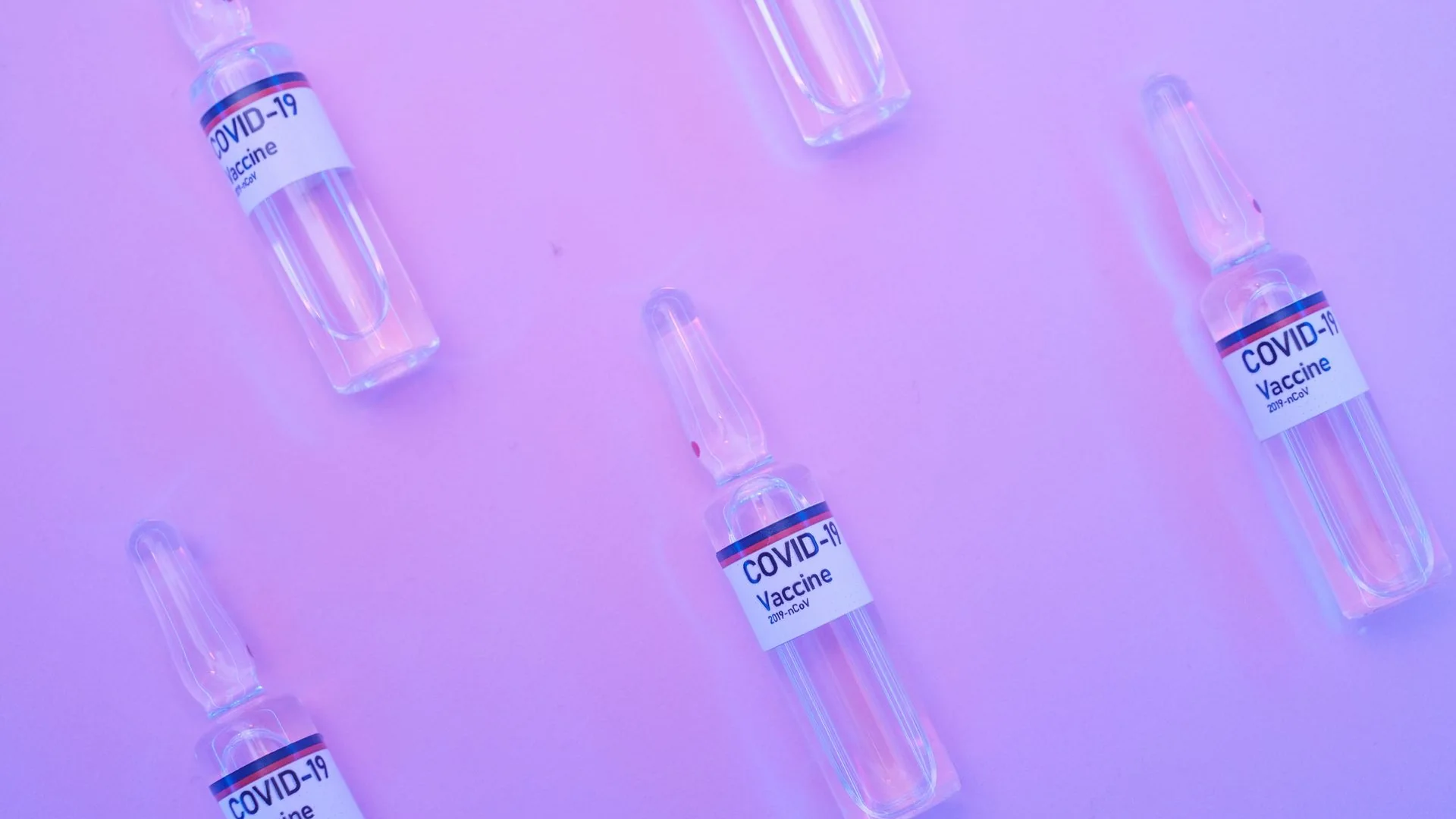 Pharmaceutical ampoules arranged on a surface.