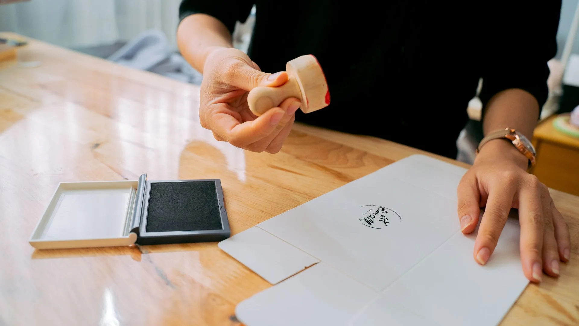 A person using a stamp on a document.